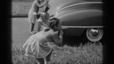 1947: kids playing and making silly faces outside by a car NEW YORK