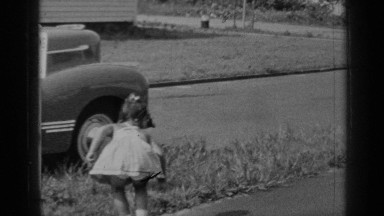 1947: a girl child putting something on grass and enjoying running with her