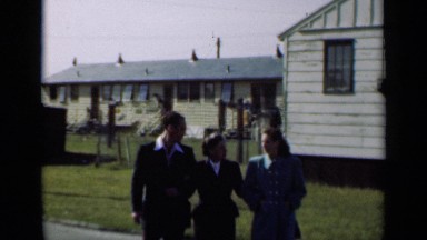 1947: three peoples are walking and talking something through pathway NEW YORK