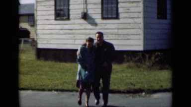 1947: romantic couple walking in a small neighborhood. NEW YORK