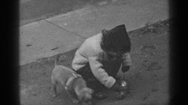 1947: a young girl, bundled up against the cold, digs in the dirt with her