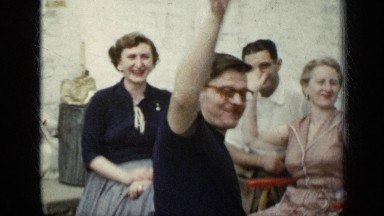 1948: family enjoy each others company in a back garden and wave to the camera.