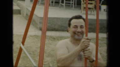 1948: the father is played with his son in park at evening time moving