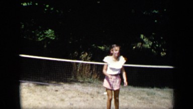 1948: girl playing tennis in the lawn and hit the ball during morning NEW YORK