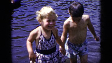 1948: the girl and the boy playing in the river bank NEW YORK
