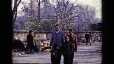 1948: a family husband and wife with kids are walking at the park