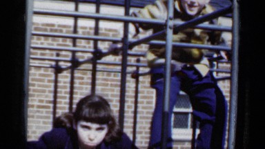 1950: a boy and girl playing on the metallic structure with different layers