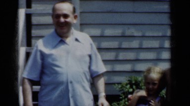 1950: a group of people standing in front of a home. NEW YORK