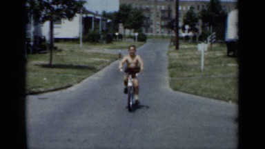 1950: a 10 year old boy is riding the cycle,smiling NEW YORK