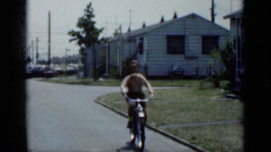 1950: just two young kids riding their bikes up and down the street NEW YORK
