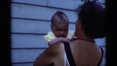 1950: the mother take care of her beautiful baby standing on the land NEW YORK