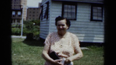 1950: a woman and a guy are talking outside of their house and the man moving