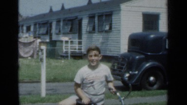 1950: boy rides cycle with more happy and smile during morning NEW YORK