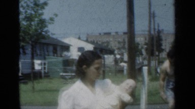 1950: the mother take care of her beautiful baby standing on the road NEW YORK