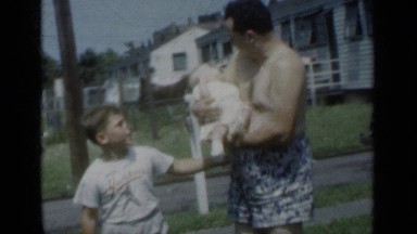 1950: father lovingly holds new baby outside house with son. NEW YORK
