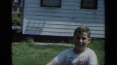 1950: a happy boy rides his bicycle through the neighborhood. NEW YORK