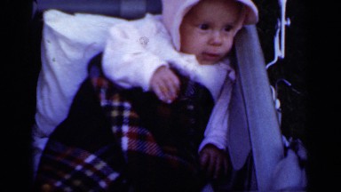 1950: fussy baby swaddled in heavy blanket squirms in carriage NEW YORK
