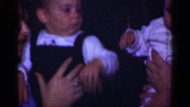1950: two ladies are taking their kids in her hands and try to make the two kids