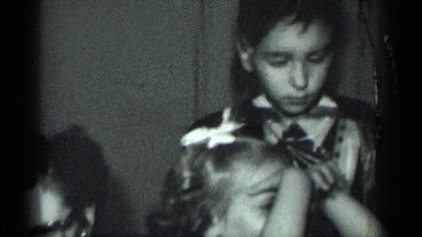 1950: generations of an extended family pose in a household scene