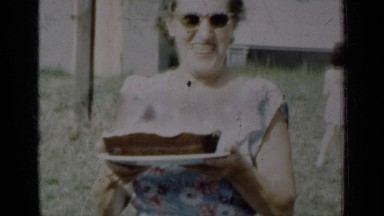 1950: grandmother with a cake, grand mother celebrates birthday with cake