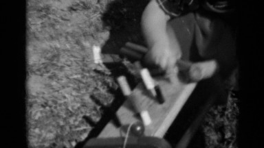 1950: a little cute kid playing alone with her play material at the front of her