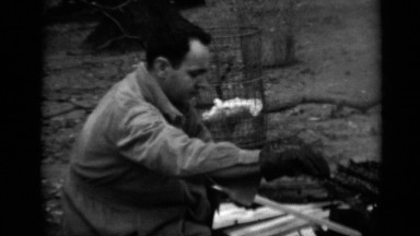 1950: family outing with dad loading wood into the campfire