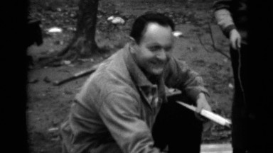 1950: two people about to make fire with pieces of wood in an open area NEW YORK