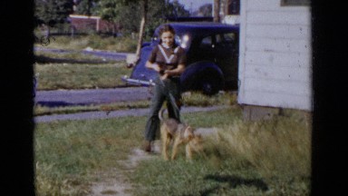 1951: young girl brings home puppy for the first time NEW YORK
