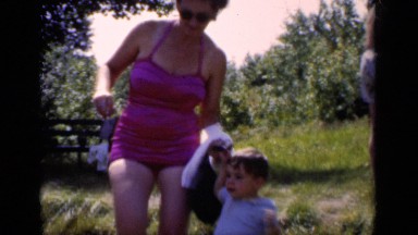 1951: the small boy holding his mother hand and walking on the way NEW YORK
