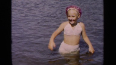 1951: a cute and pretty girl playing around in the water on a bright sunny day