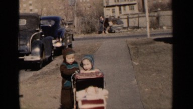 1951: the beautiful children taking baby cart on the road side NEW YORK