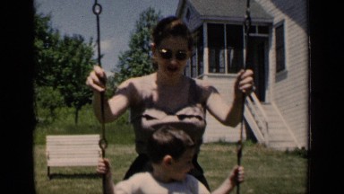 1951: a mother and her adorable son playing in the park outside their home