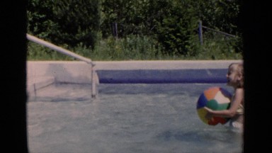 1951: two girls in a pool playing with a big ball. NEW YORK