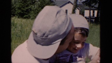 1951: A Man Lovingly Holding and Kissing a Child in New York