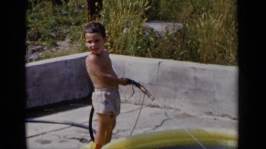 1951: the small beautiful boy pouring the water through the tube NEW YORK