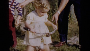 1951: woman trying to teach their kid to use cycle alone