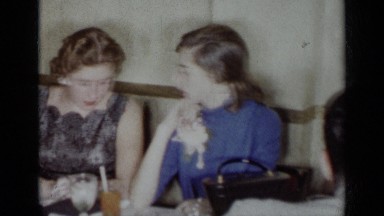 1954: panning footage of well dressed young people at a party. NEW YORK