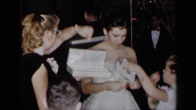 1954: bride opens gifts around family and friends NEW YORK