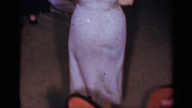 1954: a woman alone dancing at the party in front of her husband and enjoying