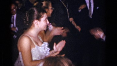 1954: young men and women dance and clap at a formal celebration. NEW YORK