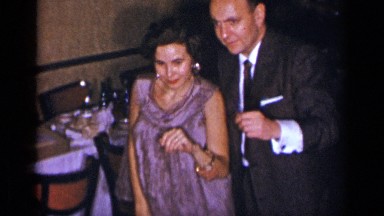 1954: man and woman attend a formal event and dance together, looking excited