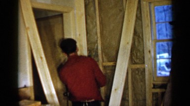 1957: worker repairing a house door for a handicapped man at his house