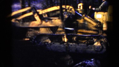 1957: a yellow construction machine being used to transport dirt from location