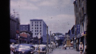 1957: cars are moving on the road at the morning traffic time at a main city.