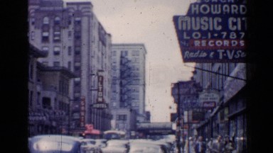 1957: an antique city scene showing vehicles, buildings, and people CHICAGO