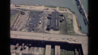 1958: aerial view of freeways along the shoreline. CHICAGO