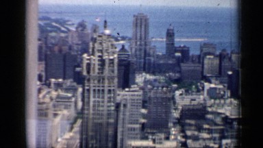 1958: the panoramic view of a city with skyscrapers on the shore of the sea