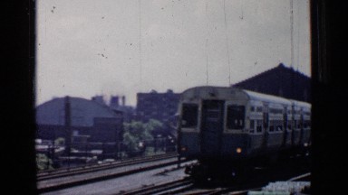 1958: a train is moving slowly train just started departing CHICAGO