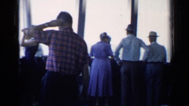 1958: crowd of people look out of the windows on a observation