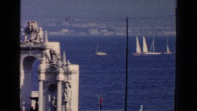 1960: several boats cruising along the coastline